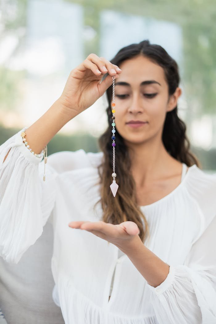 A woman holding a crystal for chakra healing, focusing on spirituality and wellness.